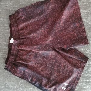 Red and black under armour swim trunks.